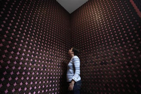 A woman stands next to more than 2,000 chocolate samples adhered to the walls inside "Mucho", a chocolate museum, in Mexico City October 29, A woman stands next to more than 2,000 chocolate samples adhered to the walls inside "Mucho", a chocolate museum, in Mexico City October 29,