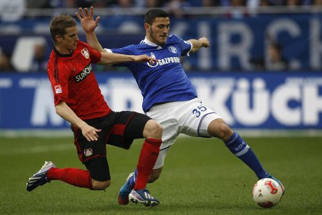 Bayer Leverkusen's Lars Bender tackles Schalke 04's Sead Kolasinac (R) during their German first division Bundesliga soccer match in Gelsenk Bayer Leverkusen's Lars Bender tackles Schalke 04's Sead Kolasinac (R) during their German first division Bundesliga soccer match in Gelsenk