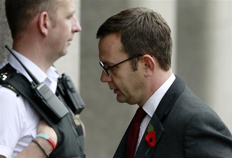 Former News of the World editor Andy Coulson (R) passes a police officer as he returns to court after a lunch recess at the Old Bailey court Former News of the World editor Andy Coulson (R) passes a police officer as he returns to court after a lunch recess at the Old Bailey court
