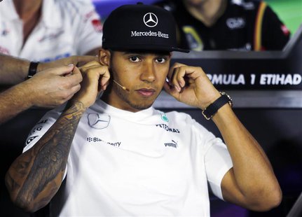 Mercedes Formula one driver Lewis Hamilton of Britain adjusts his microphone as he attends a news conference ahead of the Abu Dhabi F1 Grand Mercedes Formula one driver Lewis Hamilton of Britain adjusts his microphone as he attends a news conference ahead of the Abu Dhabi F1 Grand