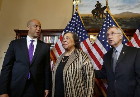 U.S. Senator-elect Cory Booker (D-NJ), and his mother, Carolyn Booker stand with U.S. Senate Majority Leader Harry Reid (L-R) before Booker U.S. Senator-elect Cory Booker (D-NJ), and his mother, Carolyn Booker stand with U.S. Senate Majority Leader Harry Reid (L-R) before Booker
