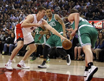 Oct 30, 2013; Toronto, Ontario, CAN; Toronto Raptors forward Tyler Hansbrough (50) tries to take the ball away from Boston Celtics forward K Oct 30, 2013; Toronto, Ontario, CAN; Toronto Raptors forward Tyler Hansbrough (50) tries to take the ball away from Boston Celtics forward K