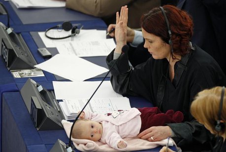 Denmark's member of the European Parliament Hanne Dahl votes as she attends with her baby a voting session at the European Parliament in Str Denmark's member of the European Parliament Hanne Dahl votes as she attends with her baby a voting session at the European Parliament in Str