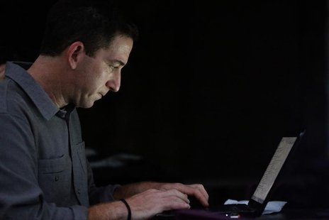 Glenn Greenwald, the blogger and journalist who broke the U.S. National Security Agency (NSA) surveillance scandal, uses his laptop after an Glenn Greenwald, the blogger and journalist who broke the U.S. National Security Agency (NSA) surveillance scandal, uses his laptop after an