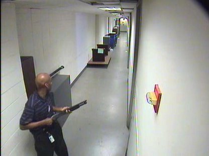 Aaron Alexis moves through the hallways of Building #197 carrying a Remington 870 shotgun in this undated handout photo released by the FBI. Aaron Alexis moves through the hallways of Building #197 carrying a Remington 870 shotgun in this undated handout photo released by the FBI.