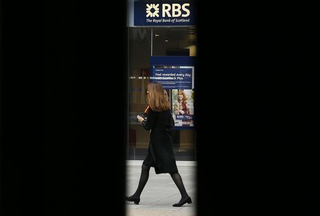 A woman is seen through scaffolding as she walks past a branch of the Royal Bank of Scotland in London September 17, 2013. REUTERS/Stefan We A woman is seen through scaffolding as she walks past a branch of the Royal Bank of Scotland in London September 17, 2013. REUTERS/Stefan We
