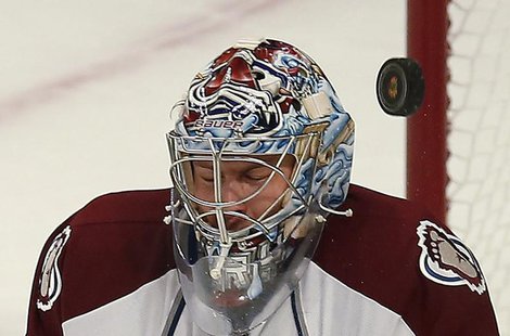 The puck goes by the mask of Colorado Avalanche's Semyon Varlamov from a shot by the Chicago Blackhawks during the second period of their NH The puck goes by the mask of Colorado Avalanche's Semyon Varlamov from a shot by the Chicago Blackhawks during the second period of their NH