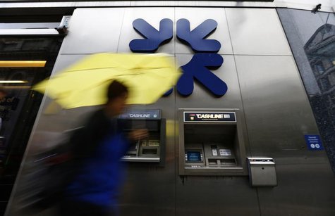 A woman shelters under an umbrella as she walks past a branch of the Royal Bank of Scotland in the City of London August 2, 2013. REUTERS/An A woman shelters under an umbrella as she walks past a branch of the Royal Bank of Scotland in the City of London August 2, 2013. REUTERS/An