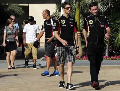 Lotus Formula One driver Romain Grosjean of France (L) arrives at a news conference ahead of the Abu Dhabi F1 Grand Prix at the Yas Marina c Lotus Formula One driver Romain Grosjean of France (L) arrives at a news conference ahead of the Abu Dhabi F1 Grand Prix at the Yas Marina c