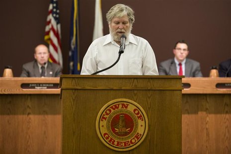 Tom Lynch delivers a Baha'i prayer before the start of a town board meeting at the Greece Town Hall in Greece, New York August 20, 2013. REU Tom Lynch delivers a Baha'i prayer before the start of a town board meeting at the Greece Town Hall in Greece, New York August 20, 2013. REU