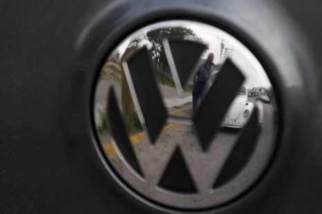 83-year-old Oscar Almaguer and his 1967 Volkswagen Beetle are reflected in the car insignia of another Volkswagen in Apodaca, on the outskir 83-year-old Oscar Almaguer and his 1967 Volkswagen Beetle are reflected in the car insignia of another Volkswagen in Apodaca, on the outskir