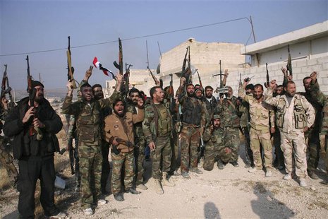 Forces loyal to Syria's President Bashar al-Assad hold up their weapons as they cheer in the town of Safira November 1, 2013. REUTERS/George Forces loyal to Syria's President Bashar al-Assad hold up their weapons as they cheer in the town of Safira November 1, 2013. REUTERS/George