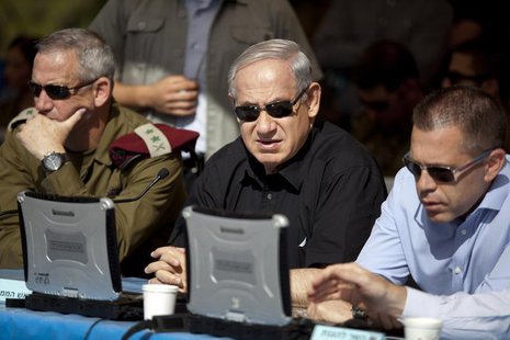 Israeli Prime Minister Benjamin Netanyahu (C) sits next to armed forces chief Major-General Benny Gantz (L) and Gilad Erdan, minister of com Israeli Prime Minister Benjamin Netanyahu (C) sits next to armed forces chief Major-General Benny Gantz (L) and Gilad Erdan, minister of com