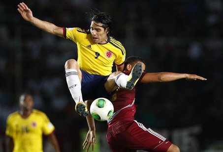 Colombia's Radamel Falcao Garcia (9) challenges Venezuela's Tomas Rincon during their 2014 World Cup qualifying soccer match in Puerto Ordaz Colombia's Radamel Falcao Garcia (9) challenges Venezuela's Tomas Rincon during their 2014 World Cup qualifying soccer match in Puerto Ordaz