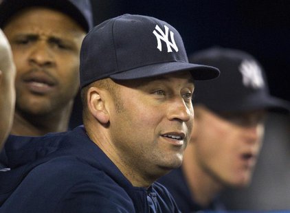 New York Yankees Derek Jeter watches play from the dugout during the seventh inning of their American League MLB baseball game against the T New York Yankees Derek Jeter watches play from the dugout during the seventh inning of their American League MLB baseball game against the T