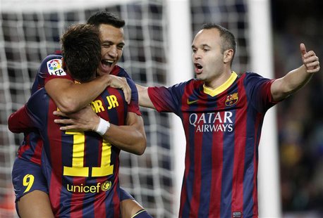 Barcelona's Alexis Sanchez (L, facing camera) celebrates a goal against Espanyol with teammates Neymar and Andres Iniesta (R) during their S Barcelona's Alexis Sanchez (L, facing camera) celebrates a goal against Espanyol with teammates Neymar and Andres Iniesta (R) during their S