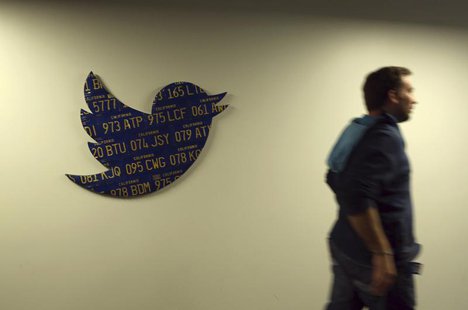 An employee walks past a Twitter logo made from Californian license plates at the company's headquarters in San Francisco, California Octobe An employee walks past a Twitter logo made from Californian license plates at the company's headquarters in San Francisco, California Octobe
