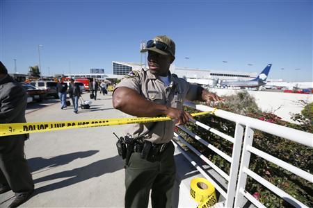 An airport police officer cordons off terminals 2 and 3 after a shooting at Los Angeles airport (LAX), California November 1, 2013.
REUTERS/Lucy Nicholson An airport police officer cordons off terminals 2 and 3 after a shooting at Los Angeles airport (LAX), California November 1, 2013.
REUTERS/Lucy Nicholson