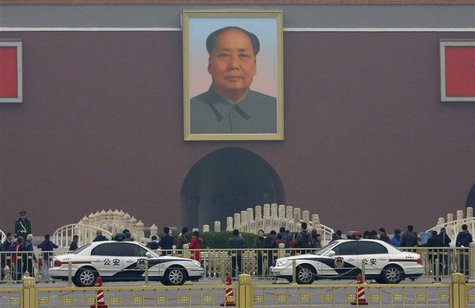 Police cars are parked in front of a giant portrait of late Chinese Chairman Mao Zedong at the main entrance of the Forbidden City in Beijin Police cars are parked in front of a giant portrait of late Chinese Chairman Mao Zedong at the main entrance of the Forbidden City in Beijin