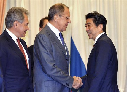 Russia's Foreign Minister Sergey Lavrov (2nd L) and Defence Minister Sergei Shoigu (L) shakes hands with Japan's Prime Minister Shinzo Abe a Russia's Foreign Minister Sergey Lavrov (2nd L) and Defence Minister Sergei Shoigu (L) shakes hands with Japan's Prime Minister Shinzo Abe a