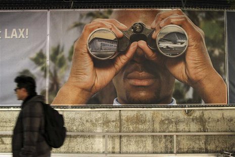A man walks past a billboard at an airport construction area after a shooting at the Los Angeles International Airport November 1, 2013. REU A man walks past a billboard at an airport construction area after a shooting at the Los Angeles International Airport November 1, 2013. REU