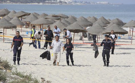 Tunisian policemen investigate near a crime scene on a beach near the tourist resort of Sousse October 30, 2013. REUTERS/Mohamed Amine ben A Tunisian policemen investigate near a crime scene on a beach near the tourist resort of Sousse October 30, 2013. REUTERS/Mohamed Amine ben A