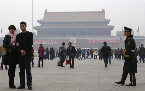 A paramilitary soldier patrols near visitors posing for souvenir pictures at Tiananmen Square in Beijing, November 1, 2013. REUTERS/Kim Kyun A paramilitary soldier patrols near visitors posing for souvenir pictures at Tiananmen Square in Beijing, November 1, 2013. REUTERS/Kim Kyun