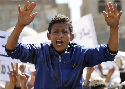 A boy shouts slogan as he sits on the back of a friend during a protest outside the home of Yemeni President Abd-Rabbu Mansour Hadi against A boy shouts slogan as he sits on the back of a friend during a protest outside the home of Yemeni President Abd-Rabbu Mansour Hadi against