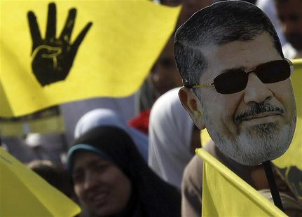 A supporter of the Muslim Brotherhood and ousted Egyptian President Mohamed Mursi takes part in a protest against the military and interior A supporter of the Muslim Brotherhood and ousted Egyptian President Mohamed Mursi takes part in a protest against the military and interior