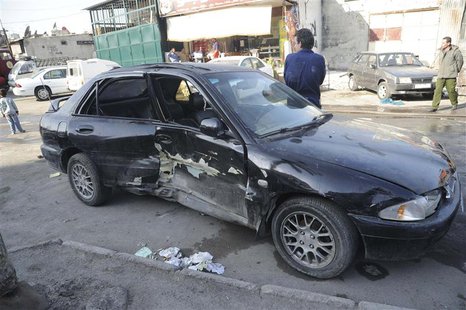 A damaged car is pictured after a mortar shell hit a textile factory at al-Dweil'a neighbourhood in Damascus on Sunday November 3, 2013, cau A damaged car is pictured after a mortar shell hit a textile factory at al-Dweil'a neighbourhood in Damascus on Sunday November 3, 2013, cau