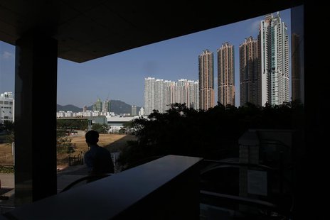 A man descends on an escalator near private housing estates in Hong Kong October 31, 2013. REUTERS/Bobby Yip A man descends on an escalator near private housing estates in Hong Kong October 31, 2013. REUTERS/Bobby Yip