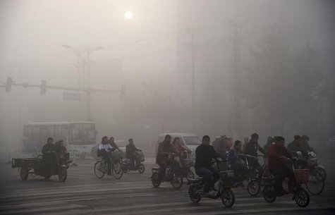 Residents ride bicycles along a street amid heavy haze in Xingtai, Hebei province November 3, 2013. REUTERS/China Daily Residents ride bicycles along a street amid heavy haze in Xingtai, Hebei province November 3, 2013. REUTERS/China Daily