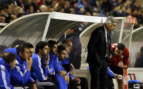 Real Madrid's coach Carlo Ancelotti (standing) reacts during their Spanish first division soccer match against Rayo Vallecano at Vallecas st Real Madrid's coach Carlo Ancelotti (standing) reacts during their Spanish first division soccer match against Rayo Vallecano at Vallecas st