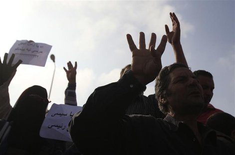 Supporters of the Muslim Brotherhood and ousted Egyptian President Mohamed Mursi shout slogans against the military and interior ministry, w Supporters of the Muslim Brotherhood and ousted Egyptian President Mohamed Mursi shout slogans against the military and interior ministry, w