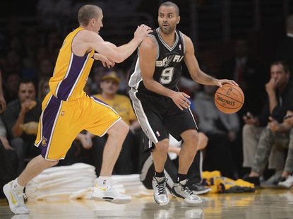 Los Angeles, CA, USA; San Antonio Spurs point guard Tony Parker (9) controls the ball against the defense of Los Angeles Lakers point guard Los Angeles, CA, USA; San Antonio Spurs point guard Tony Parker (9) controls the ball against the defense of Los Angeles Lakers point guard