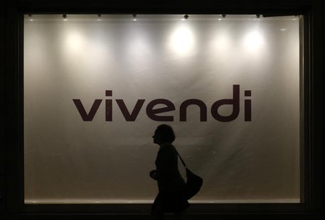 A woman is silhouetted as she walks past the main entrance of the entertainment-to-telecoms conglomerate Vivendi's headquarters in Paris, Au A woman is silhouetted as she walks past the main entrance of the entertainment-to-telecoms conglomerate Vivendi's headquarters in Paris, Au