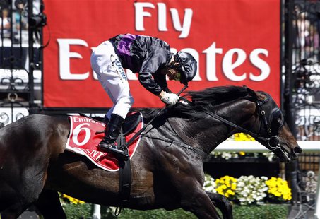 Jockey Damien Oliver crosses the finish line riding race favourite Fiorente to win the A$6 million ($5.7 million) Melbourne Cup at Flemingto Jockey Damien Oliver crosses the finish line riding race favourite Fiorente to win the A$6 million ($5.7 million) Melbourne Cup at Flemingto