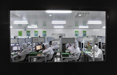 Employees work at a production line inside a factory exporting cameras used in mobile phones to Africa, in Shenyang, Liaoning province, Octo Employees work at a production line inside a factory exporting cameras used in mobile phones to Africa, in Shenyang, Liaoning province, Octo