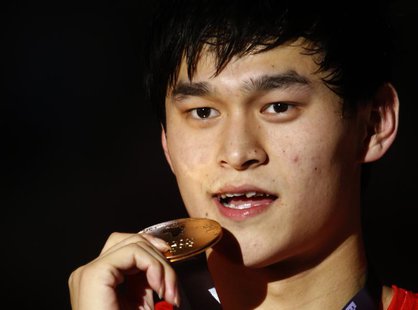 Gold medalist China's Sun Yang poses with his medal at the men's 1500m freestyle victory ceremony during the World Swimming Championships at Gold medalist China's Sun Yang poses with his medal at the men's 1500m freestyle victory ceremony during the World Swimming Championships at