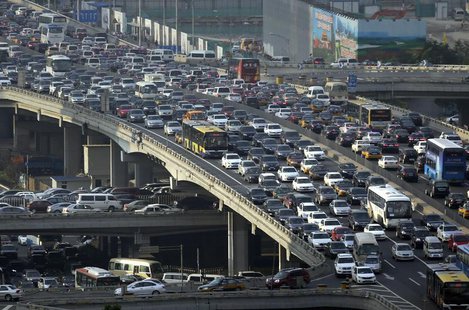 Lines of cars are pictured during a rush hour traffic jam on Guomao Bridge in Beijing July 11, 2013. REUTERS/Jason Lee Lines of cars are pictured during a rush hour traffic jam on Guomao Bridge in Beijing July 11, 2013. REUTERS/Jason Lee