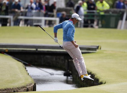 Sweden's Henrik Stenson jumps over the Swilcan Burn after chipping onto the first green during the final round of the British Open golf cham Sweden's Henrik Stenson jumps over the Swilcan Burn after chipping onto the first green during the final round of the British Open golf cham
