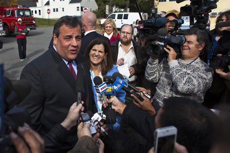 New Jersey Governor Chris Christie (L) speaks to the media, as his wife Mary Pat smiles, after casting his vote during the New Jersey govern New Jersey Governor Chris Christie (L) speaks to the media, as his wife Mary Pat smiles, after casting his vote during the New Jersey govern