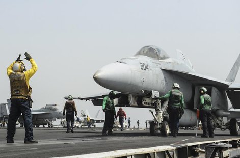 An F/A-18E Super Hornet prepares to launch from the flight deck of the aircraft carrier USS Nimitz in this U.S. Navy handout taken in the Re An F/A-18E Super Hornet prepares to launch from the flight deck of the aircraft carrier USS Nimitz in this U.S. Navy handout taken in the Re