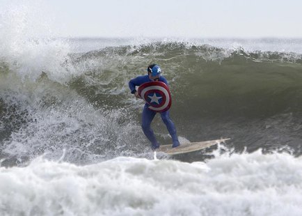 A participant dressed as Captain America surfs during the third annual Rockaway Halloween surf competition at Rockaway Beach in the Queens b A participant dressed as Captain America surfs during the third annual Rockaway Halloween surf competition at Rockaway Beach in the Queens b