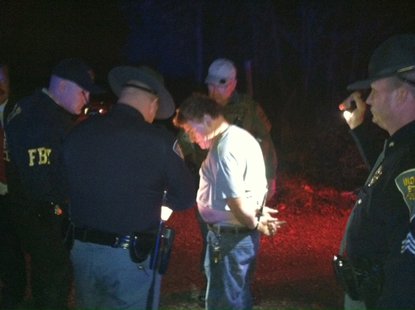 Photo 1 is Elmer Seeley (white shirt) as he is taken into custody.
photo courtesy of Indiana State Police Photo 1 is Elmer Seeley (white shirt) as he is taken into custody.
photo courtesy of Indiana State Police