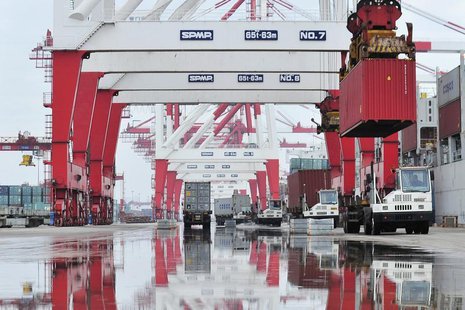 Trucks are loaded with shipping containers at a port in Yingkou, Liaoning province August 9, 2013. REUTERS/Stringer Trucks are loaded with shipping containers at a port in Yingkou, Liaoning province August 9, 2013. REUTERS/Stringer
