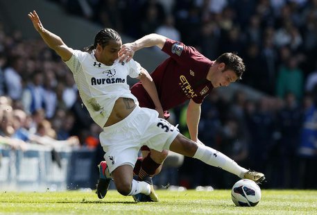 Tottenham Hotspur's Benoit Assou-Ekotto (L) challenges Manchester City's James Milner during their English Premier League soccer match at Wh Tottenham Hotspur's Benoit Assou-Ekotto (L) challenges Manchester City's James Milner during their English Premier League soccer match at Wh