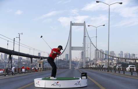 U.S. golfer Tiger Woods hits a shot during an event to promote the upcoming Turkish Airlines Open golf tournament, on the Bosphorus Bridge t U.S. golfer Tiger Woods hits a shot during an event to promote the upcoming Turkish Airlines Open golf tournament, on the Bosphorus Bridge t