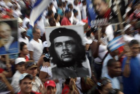 People carry an image of revolution leader Che Guevara during the May Day parade in Havana's Revolution Square May 1, 2013. REUTERS/Enrique People carry an image of revolution leader Che Guevara during the May Day parade in Havana's Revolution Square May 1, 2013. REUTERS/Enrique