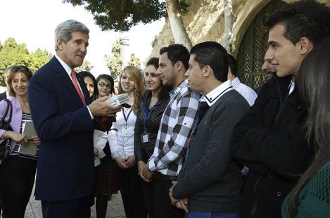 U.S. Secretary of State John Kerry greets Palestinian youth who presented him with a gift box at Manger Square in Bethlehem November 6, 2013 U.S. Secretary of State John Kerry greets Palestinian youth who presented him with a gift box at Manger Square in Bethlehem November 6, 2013